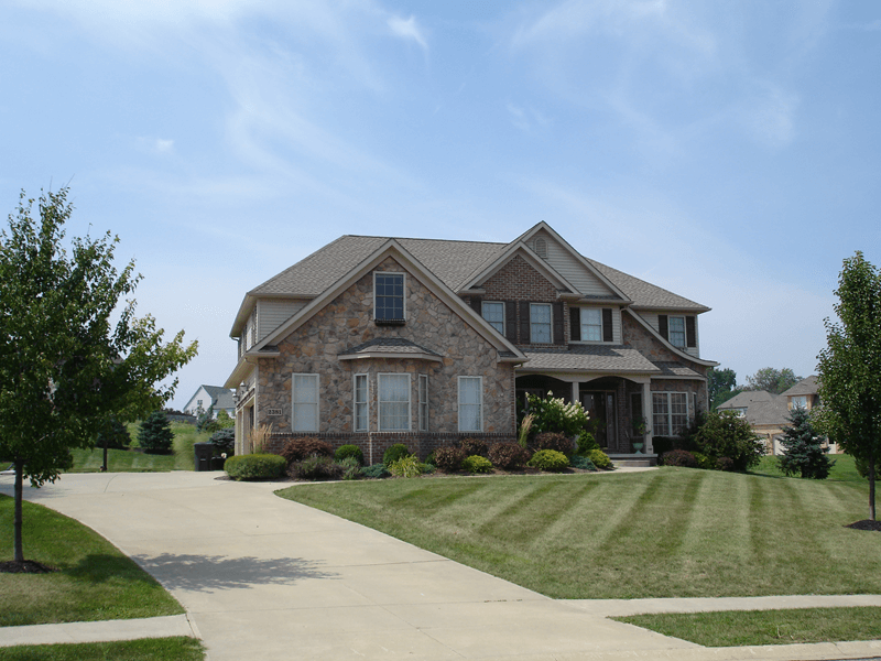 Exterior-of-large-home-with-faux-stone-siding.png